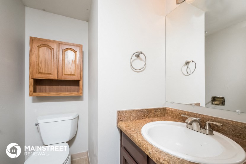 a bathroom with a sink and a toilet and a mirror