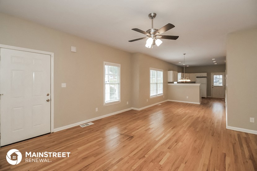 the living room and kitchen of an open floor plan