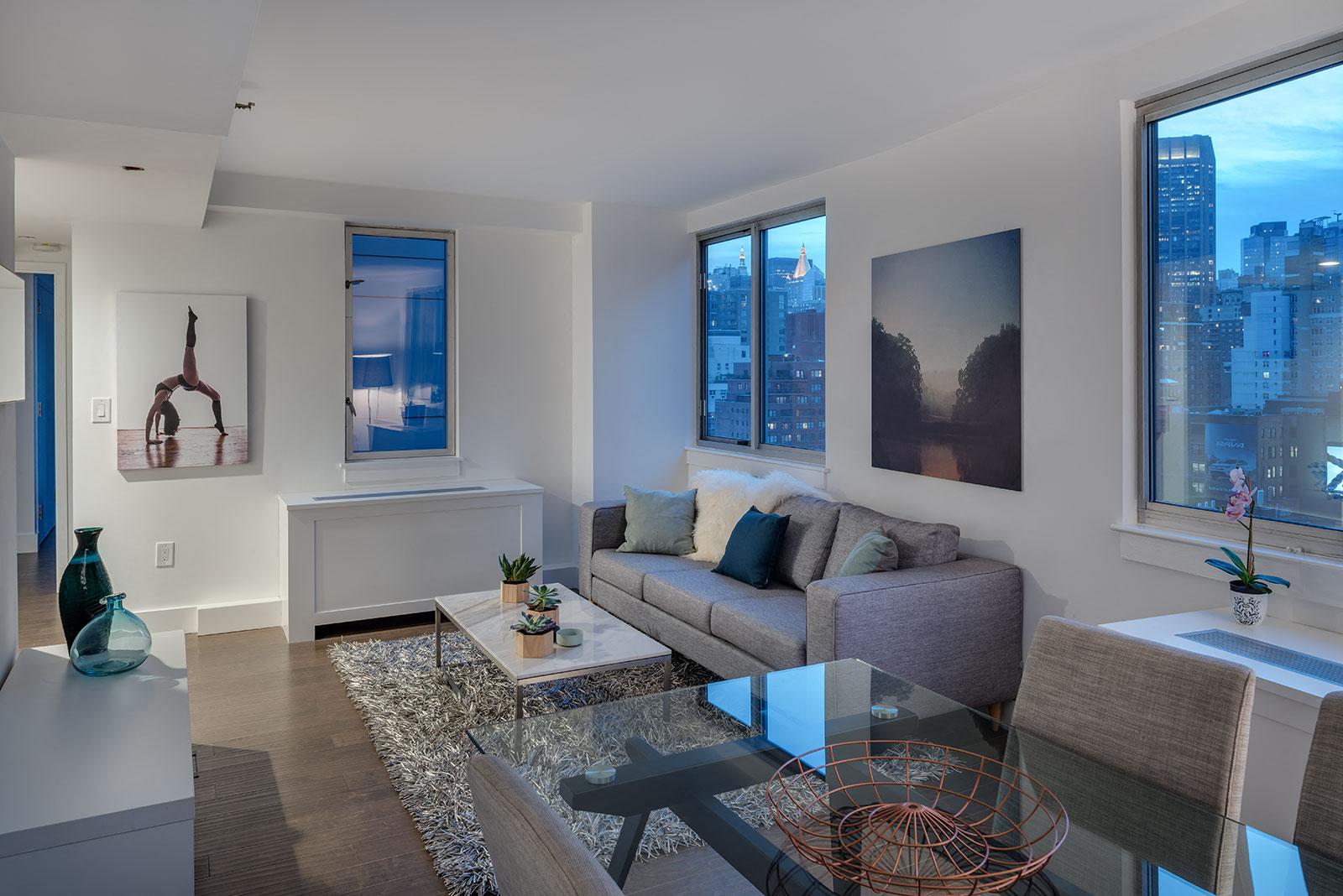 a living room with a couch and a glass table