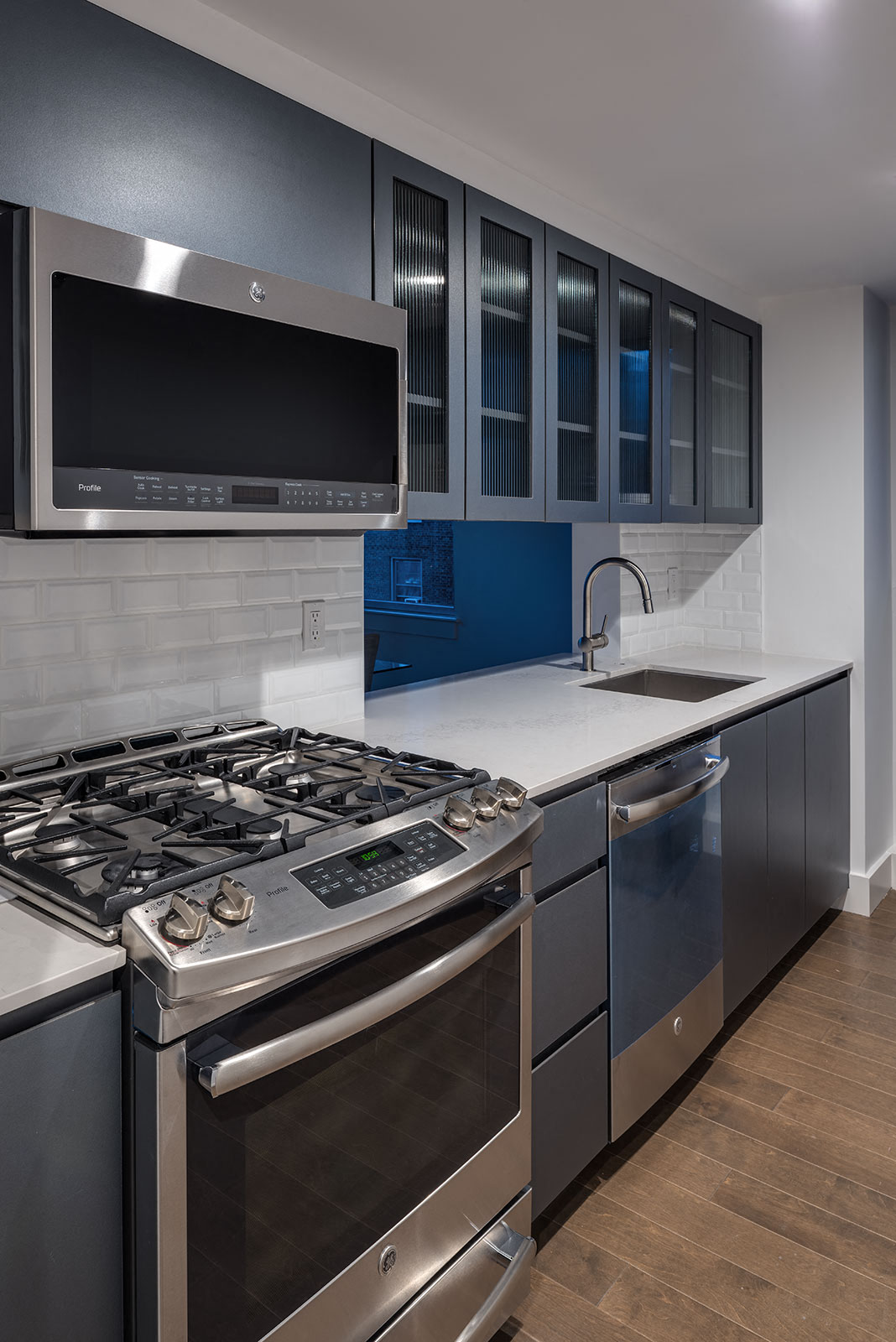 a kitchen with a stove and a sink and a microwave