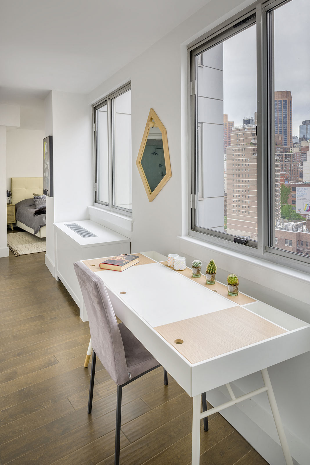 a home office with a desk and a window