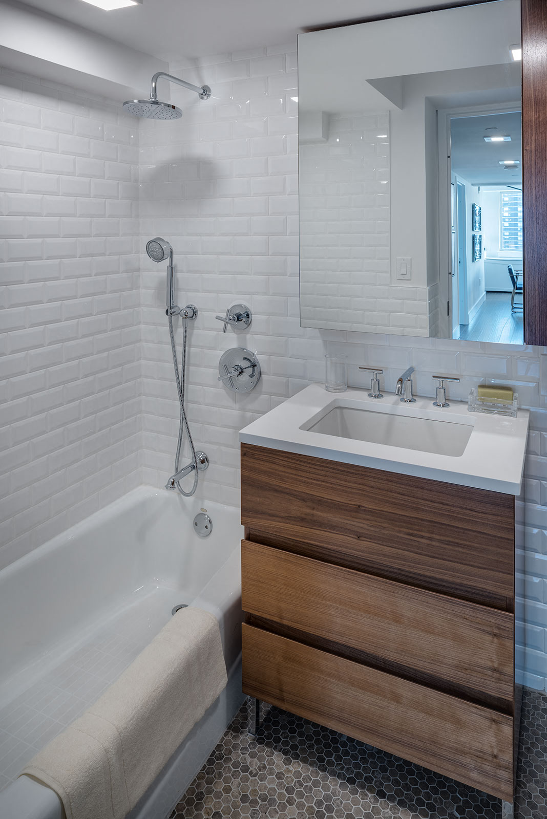 a bathroom with a sink and a tub and a mirror