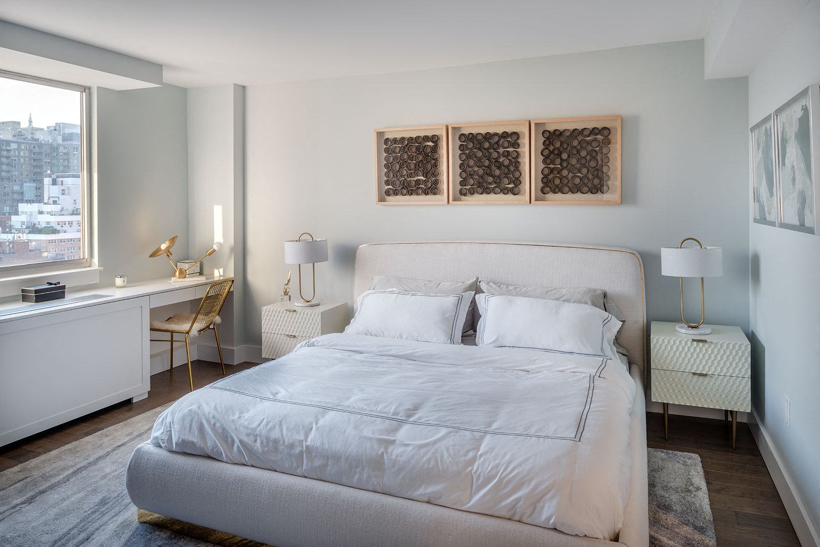 a bedroom with a bed and a desk and a window