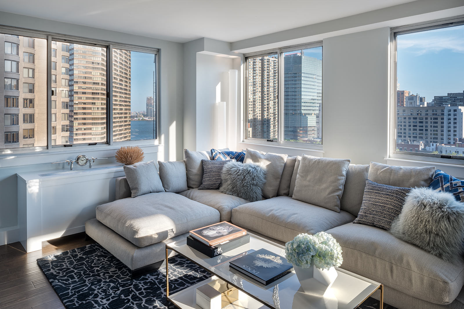 a living room with a couch and a coffee table and a view of the city