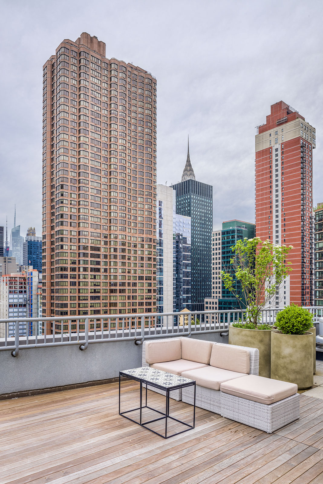 a terrace with a couch and a view of the city