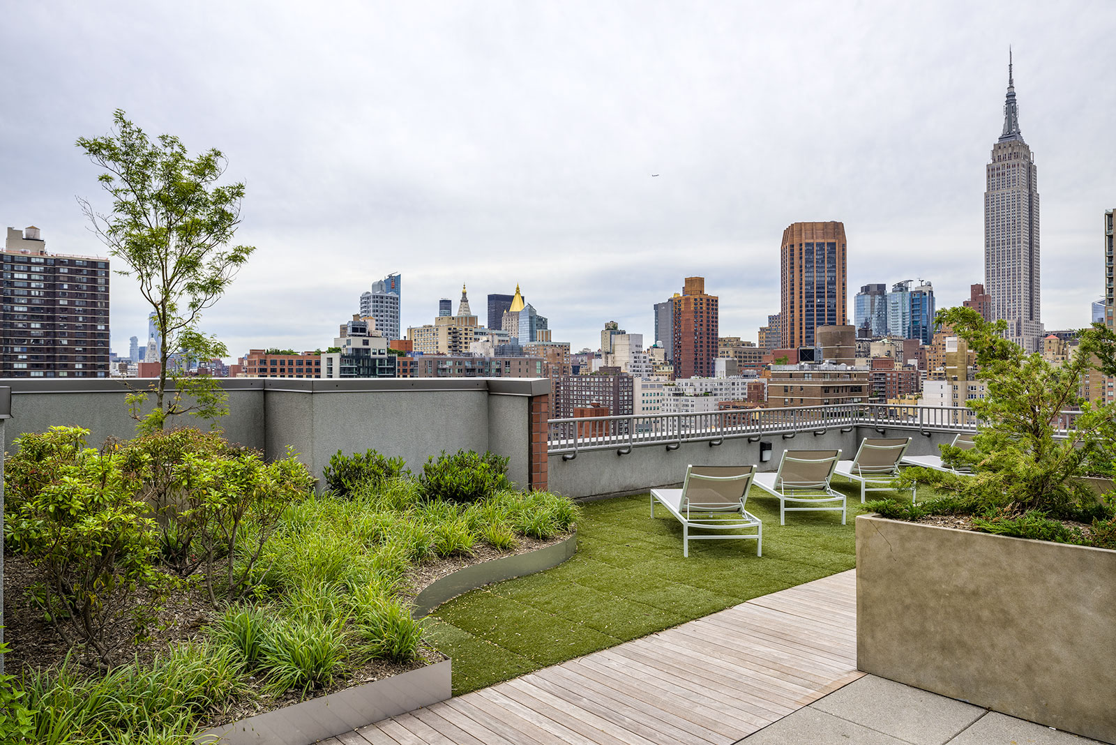 a roof terrace with a view of the empire state building and the city skyline