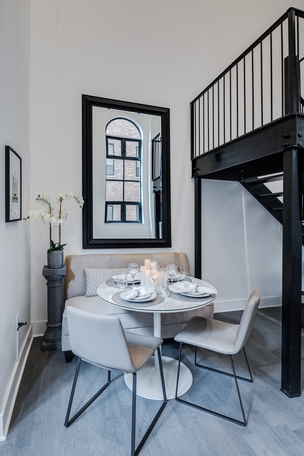 a dining room with a table and chairs and a staircase