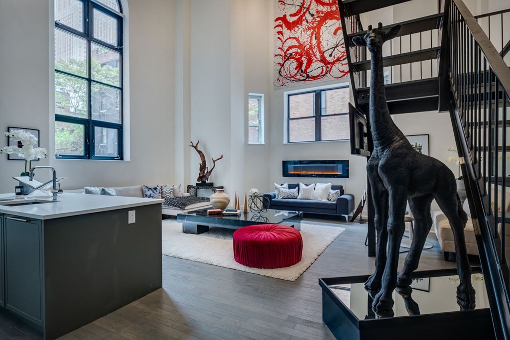 a living room with a statue of a giraffe in the center of it