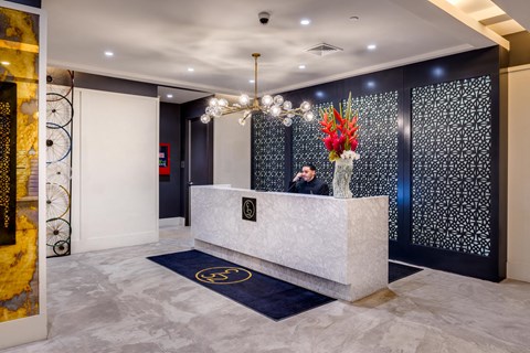 a man sitting at a desk in a lobby of a building