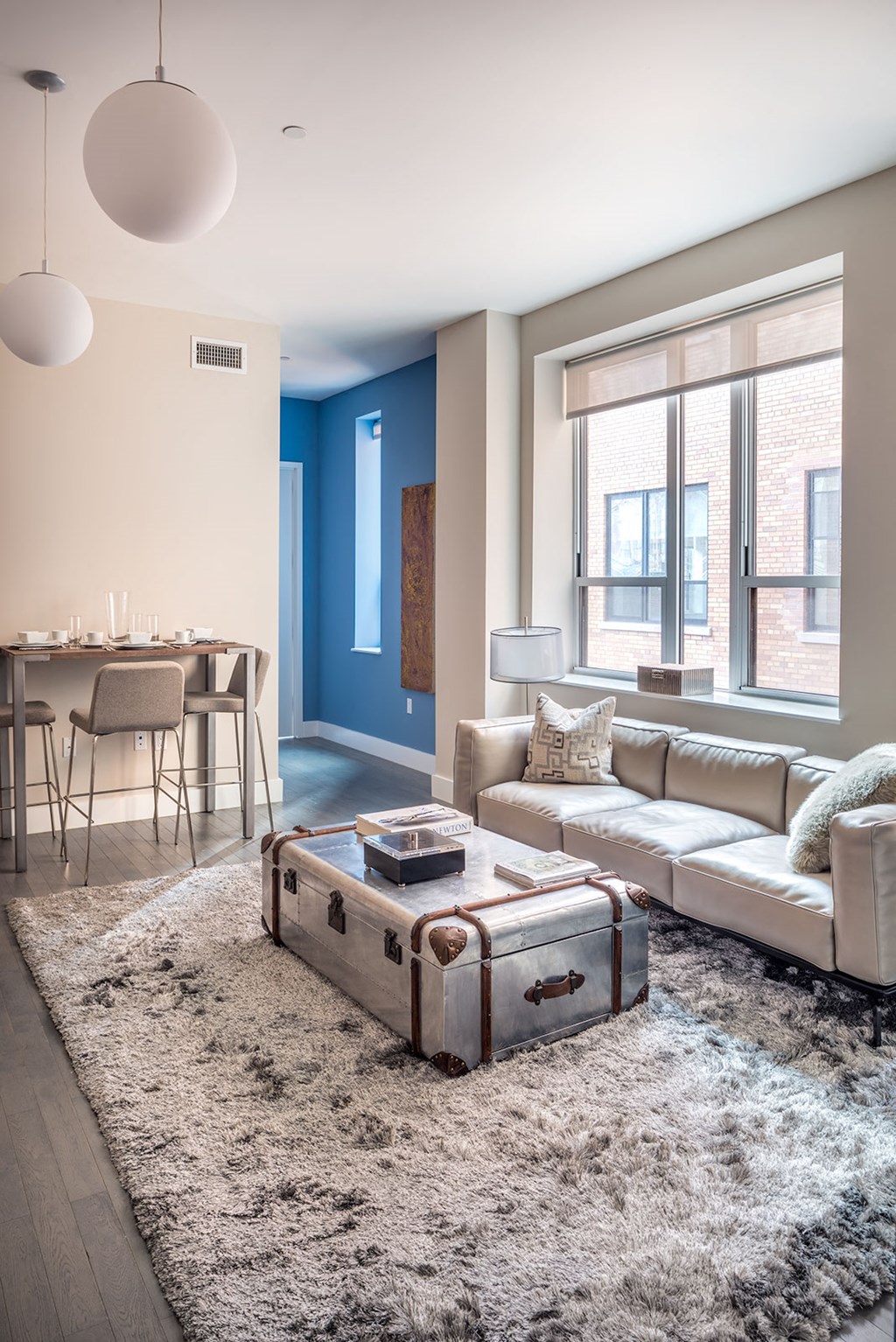 a living room with a couch and a suitcase