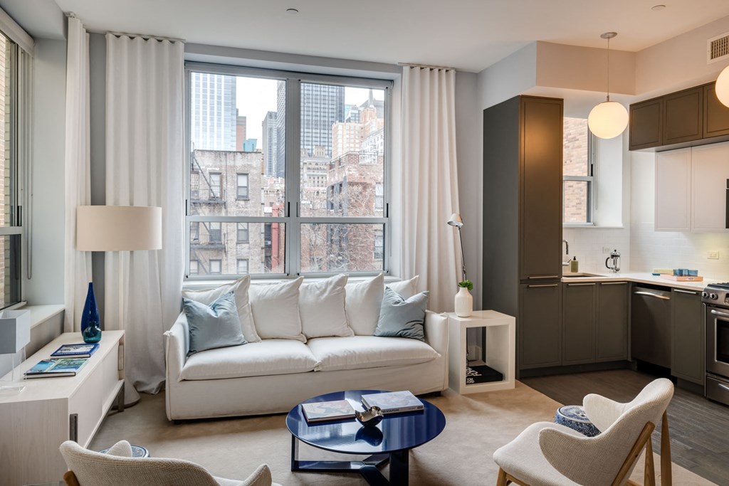 a living room with a white couch and a large window
