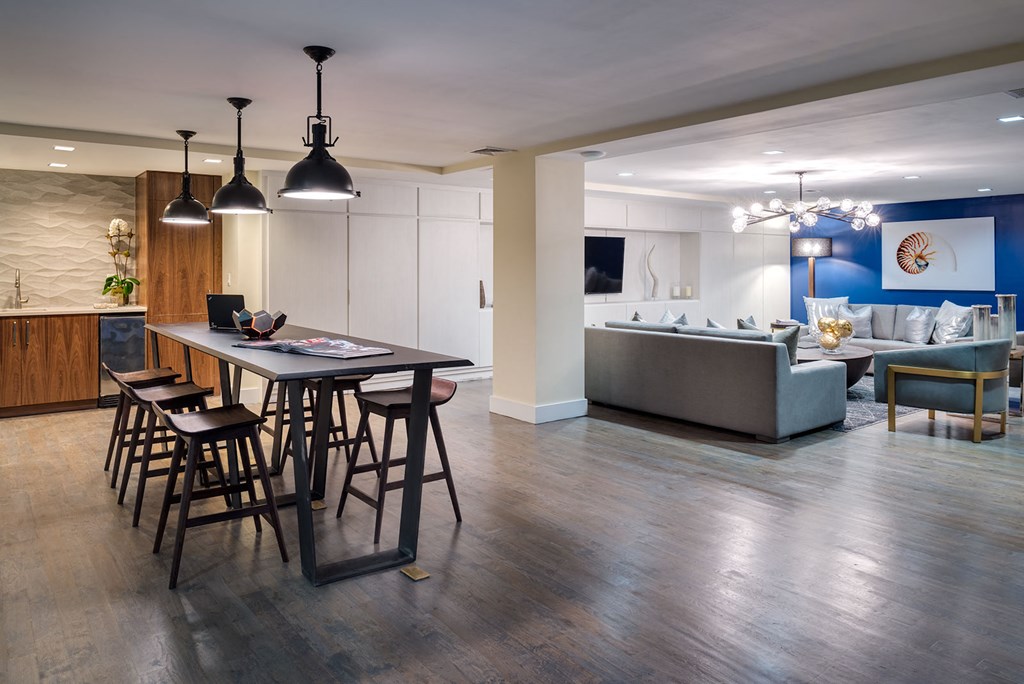 a kitchen and living room with a table and chairs