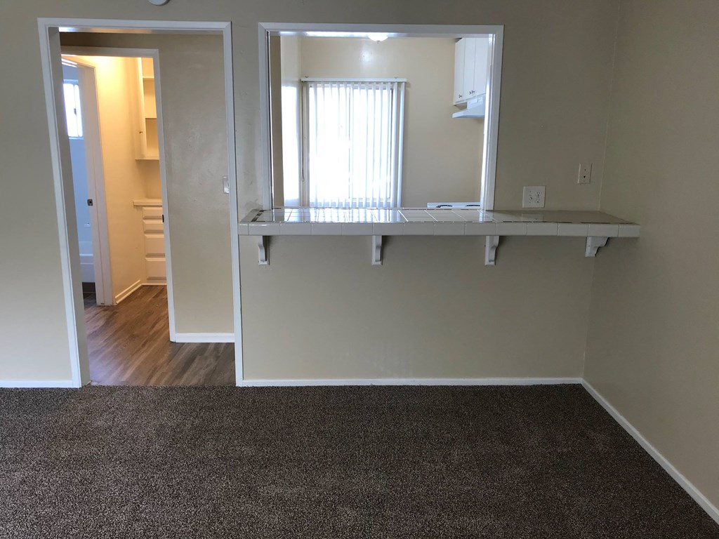 a room with a mirror on the wall and a carpet