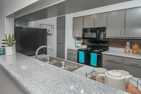 a kitchen with stainless steel appliances and granite counter tops