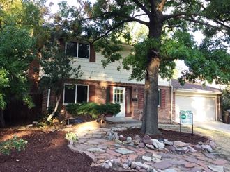 a house with a tree in front of it