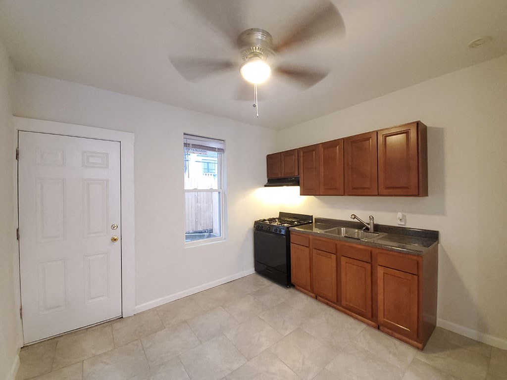 a kitchen with a ceiling fan and a sink