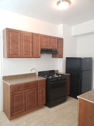 a kitchen with a stove and a refrigerator