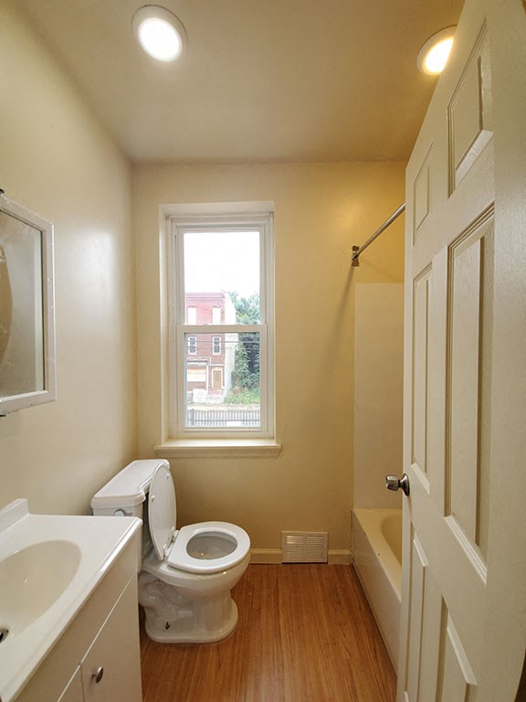 a bathroom with a toilet and a window