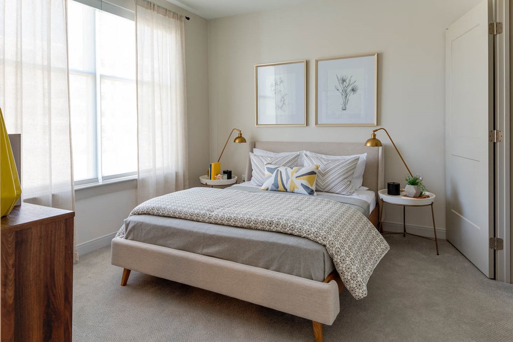 a bedroom with a bed and two windows