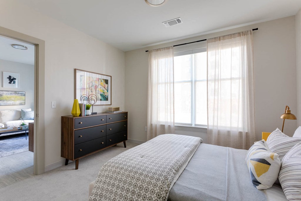 a bedroom with a bed and a dresser