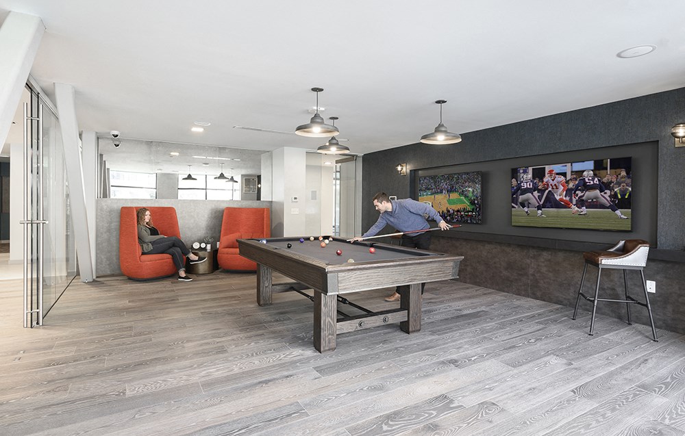 a games room with a pool table and a tv