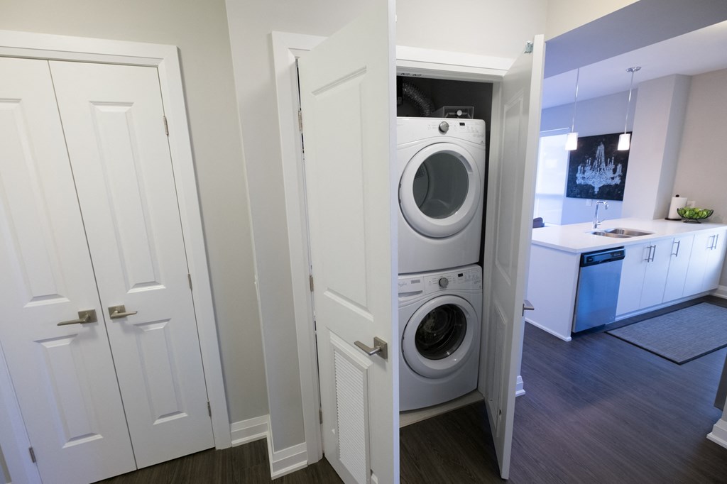 a small laundry room with a washing machine and a washer and dryer
