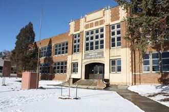 a large brick building with snow in front of it