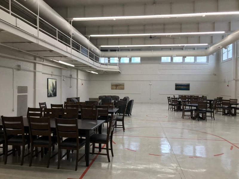 a large room filled with tables and chairs in a hall