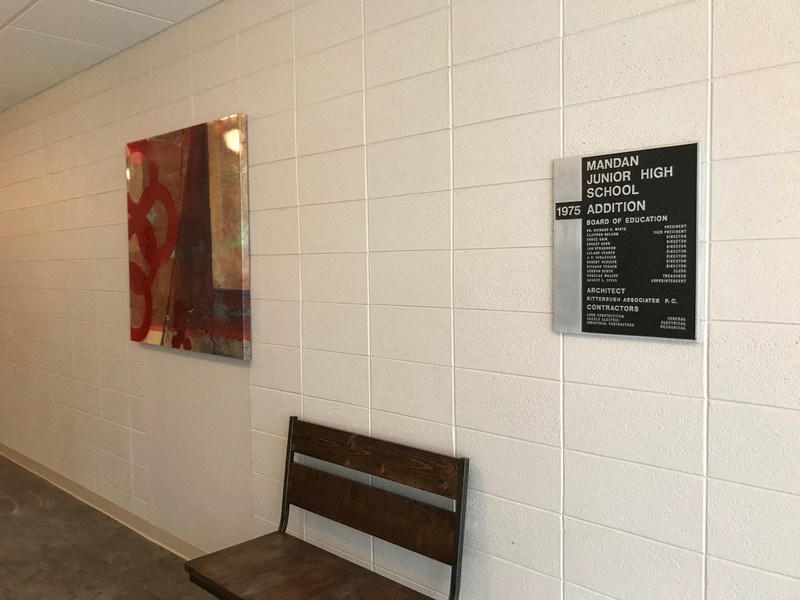 a bench and a painting on the wall of a building