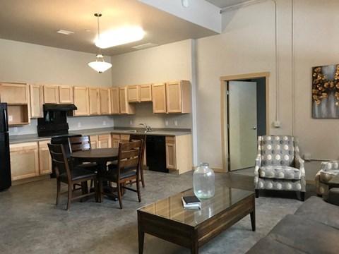 a living room and kitchen with a table and chairs