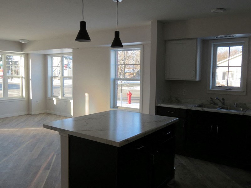 an empty kitchen with an island in the middle of it
