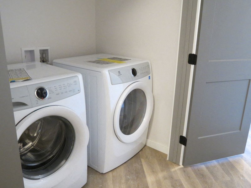 a washing machine and a dryer in a laundry room