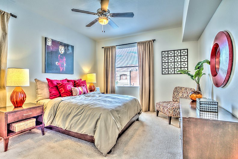 a bedroom with a bed and a ceiling fan