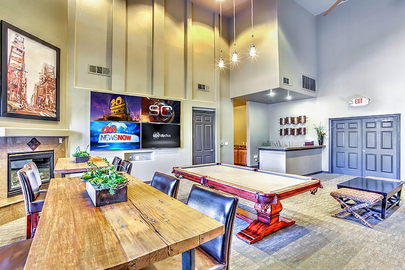 a game room with a pool table and a dining table