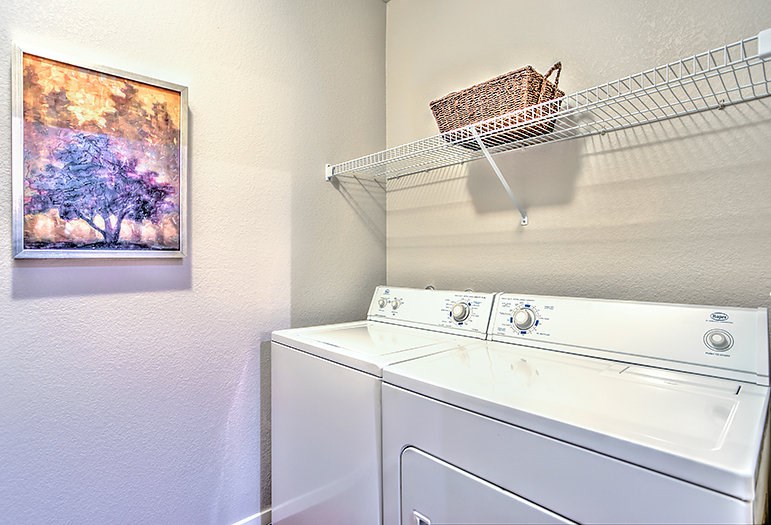 a white washer and dryer in a laundry room