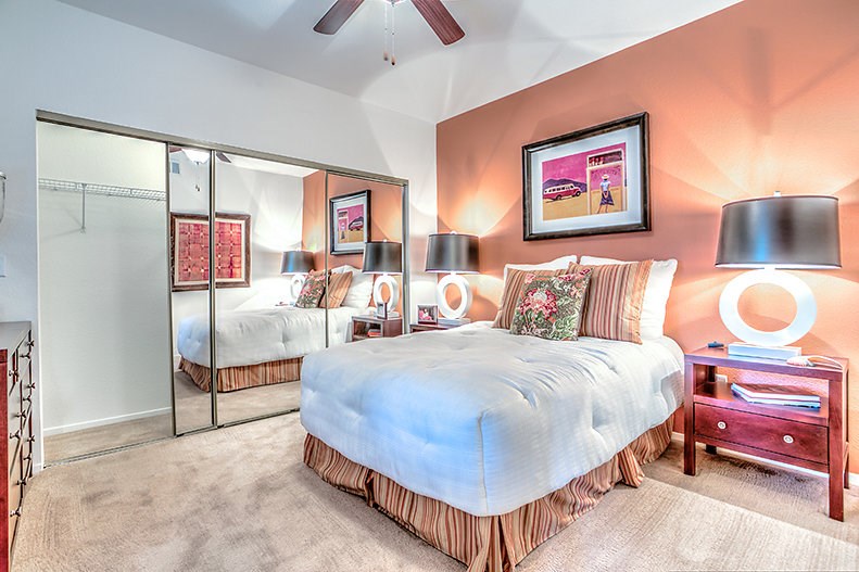 a bedroom with a bed and a mirror