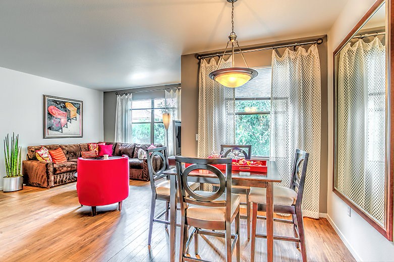 a dining room and living room with a table and chairs