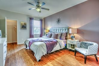 a bedroom with a bed and a ceiling fan