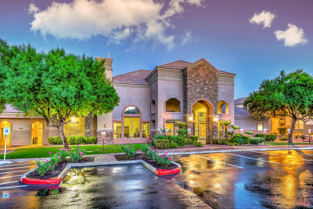 a city street with a building with a fountain