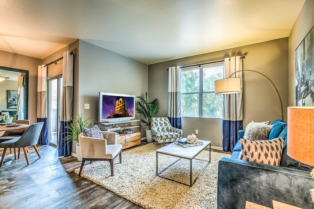 a living room with a couch and chairs and a fireplace