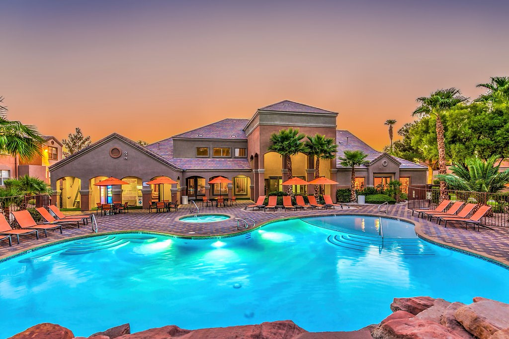 a large swimming pool in front of a house