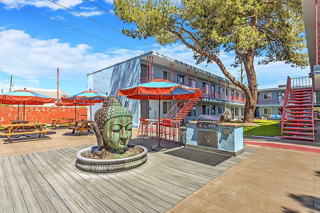 a building with a sculpture of a head on a patio