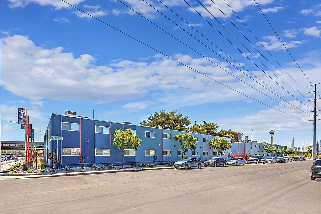 a large blue building with cars parked in front of it