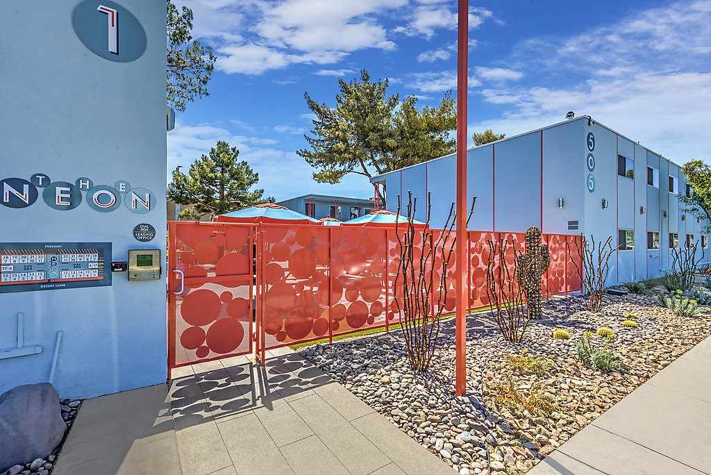 a blue building with a red fence in front of it