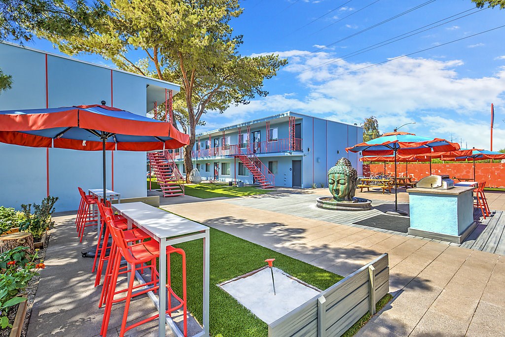 a patio with tables and chairs and umbrellas