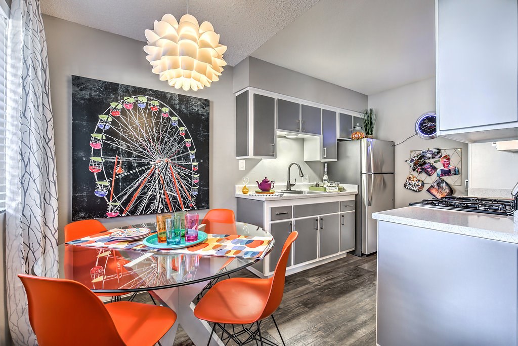 open kitchen and dining room with a ferris wheel painting on the wall