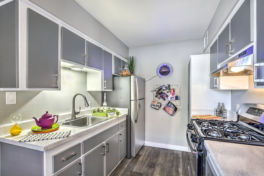 a kitchen with stainless steel appliances and white cabinets