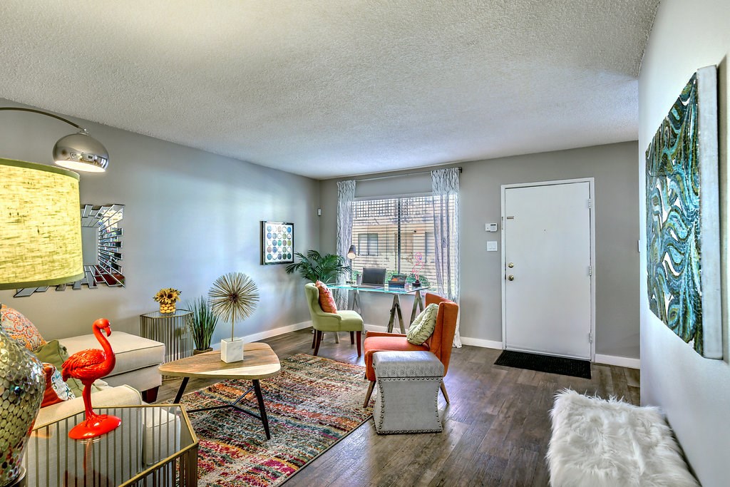 a living room with a couch and chairs and a table
