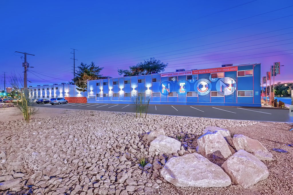 the building in which the motel is located is lit up at night
