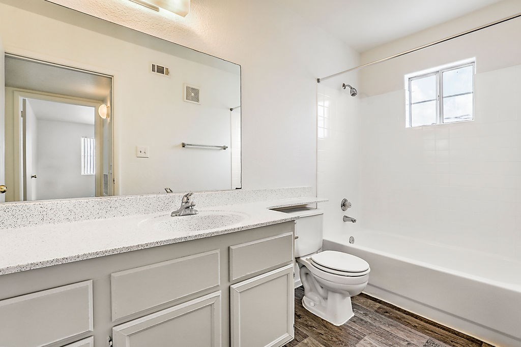 a white bathroom with a toilet and a sink